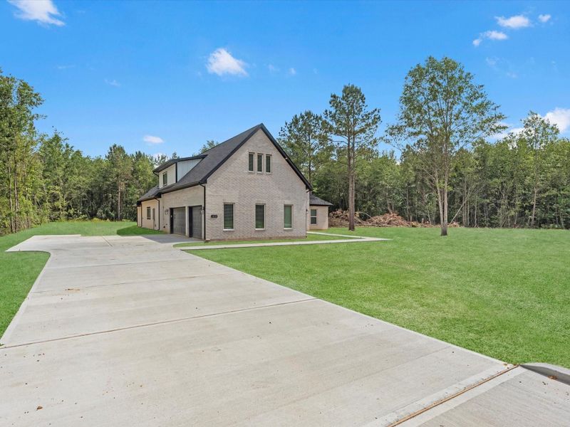 Front exterior of a new home in , Dayton, TX, highlighting curb appeal (Image 23).