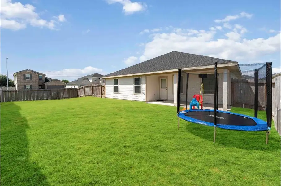 Another view of the spacious backyard with a well-maintained lawn, featuring a covered patio. This backyard is perfect for family activities and outdoor enjoyment. Another view of the spacious backyard with a well-maintained lawn, featuring a covered patio. This backyard is perfect for family activities and outdoor enjoyment.