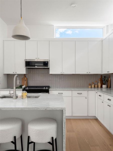 Culinary excellence awaits in this well-appointed kitchen, featuring pristine countertops and ample storage.