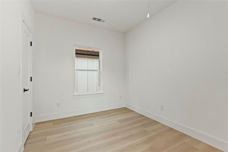 Empty room featuring light wood-style floors and baseboards