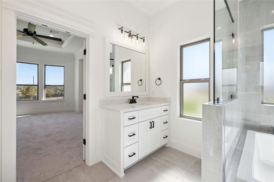 Bathroom featuring ornamental molding, vanity, separate shower and tub, ceiling fan, and tile patterned flooring