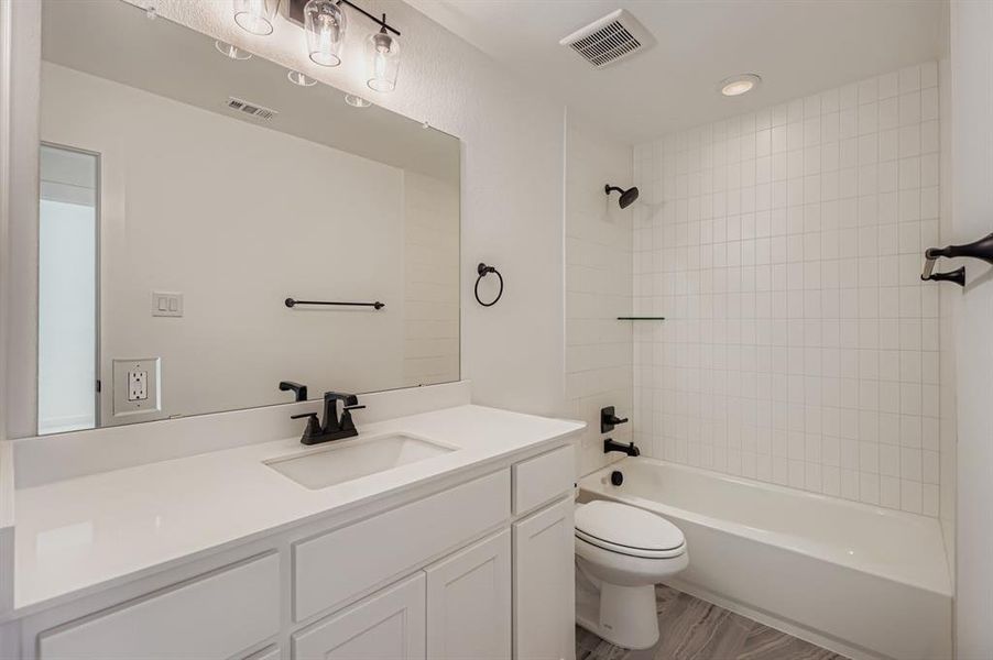 Full bath with tub / shower combination, vanity, and recessed lighting Full bath with tub / shower combination, vanity, and recessed lighting