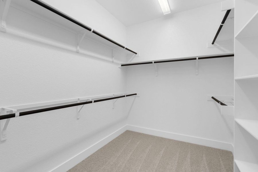 Walk-in closet in Primary Bedroom Walk-in closet in Primary Bedroom