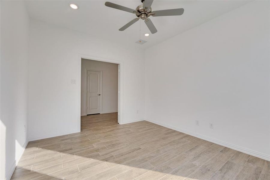 Spare room featuring ceiling fan and light hardwood / wood-style floors