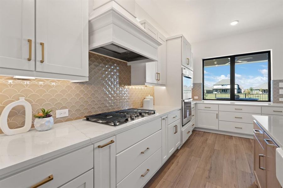 Quartz (Etheral Glow) countertops with gold fixtures and hardware