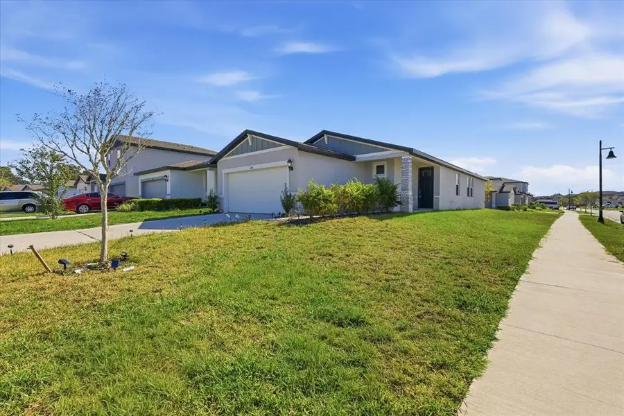 Front exterior of a new home in Park East, Plant City, FL, highlighting curb appeal (Image 1). Front exterior of a new home in Park East, Plant City, FL, highlighting curb appeal (Image 1).