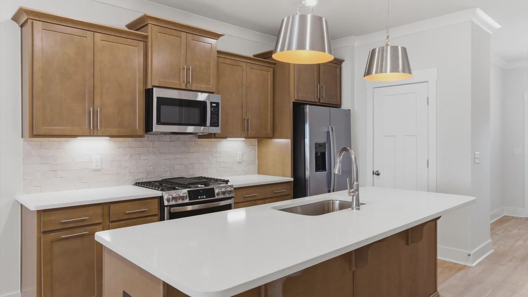 Memorable meals begin in this vibrant kitchen with pendant lighting and a thoughtfully designed island at Pelham Crossing