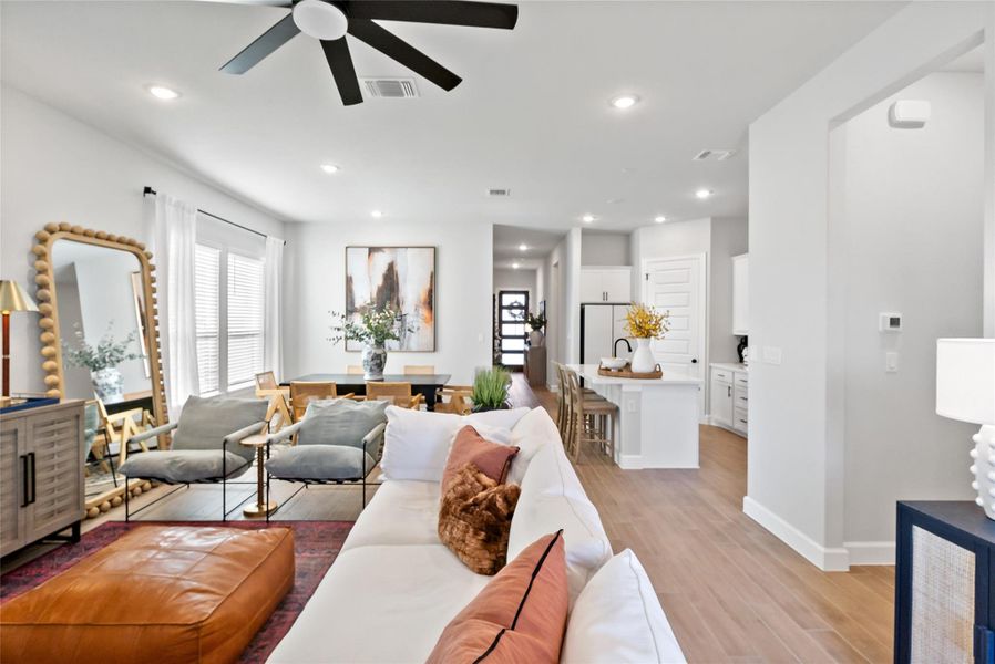 Living room featuring light wood finished floors, recessed lighting, and a ceiling fan