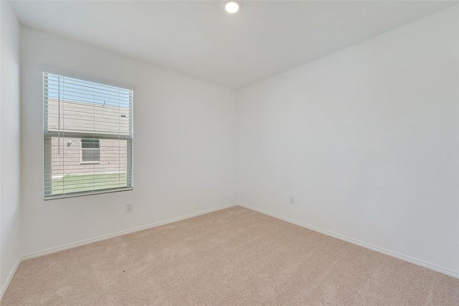 Empty room featuring light carpet and plenty of natural light