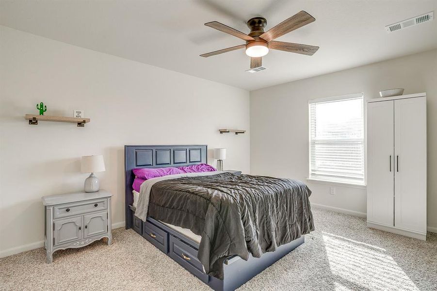 Bedroom featuring light carpet and ceiling fan