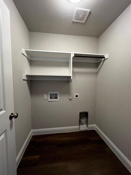 Laundry area featuring gas dryer hookup, a textured ceiling, dark hardwood / wood-style floors, hookup for a washing machine, and electric dryer hookup