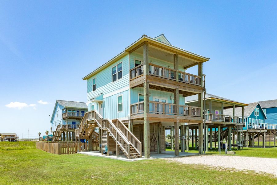 Spacious covered balcony offers ample seating and a comfortable outdoor living space, perfect for enjoying the coastal breeze.