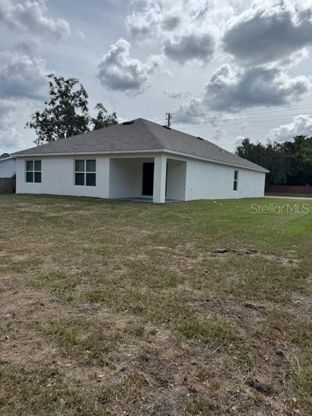 Exterior details and patio area of a home in Hernando County Spot Lots, Spring Hill (Image 23).