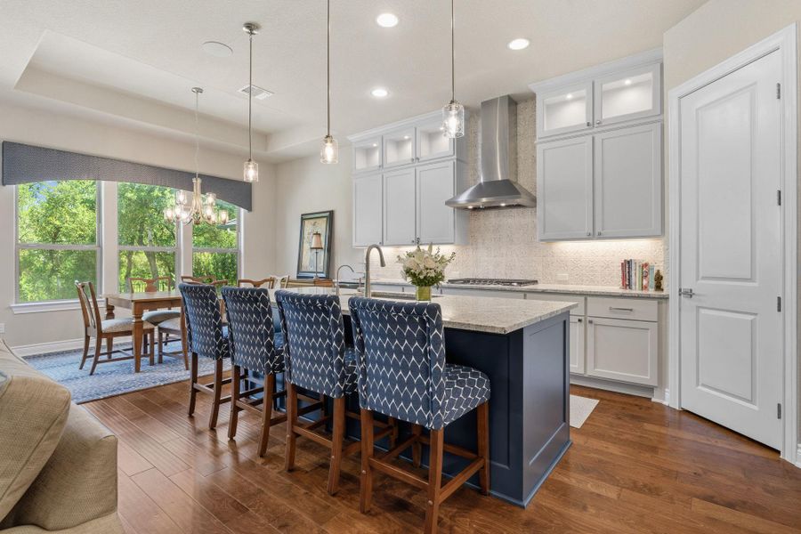 A large contrasting island offers seating, storage, and a natural gathering space. A large contrasting island offers seating, storage, and a natural gathering space.