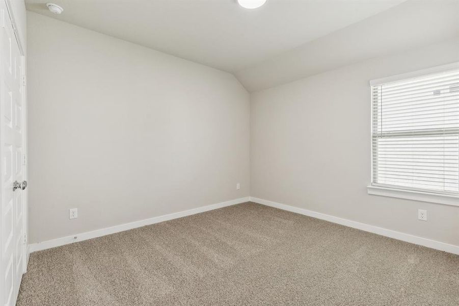 Bedroom in the Heisman home plan by Trophy Signature Homes – REPRESENTATIVE PHOTO