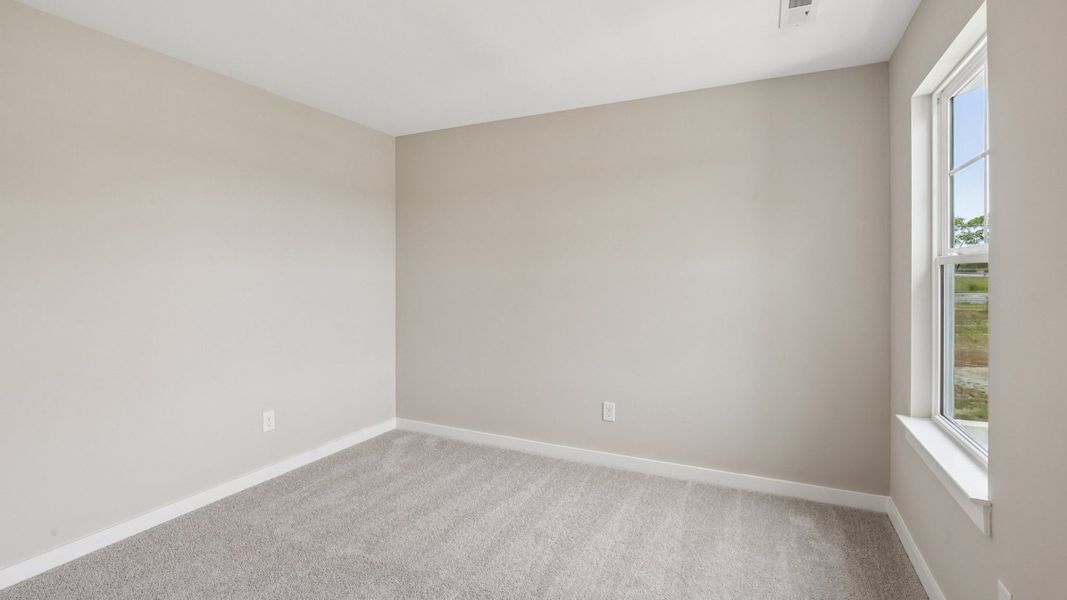Bedroom with carpet and window Bedroom with carpet and window