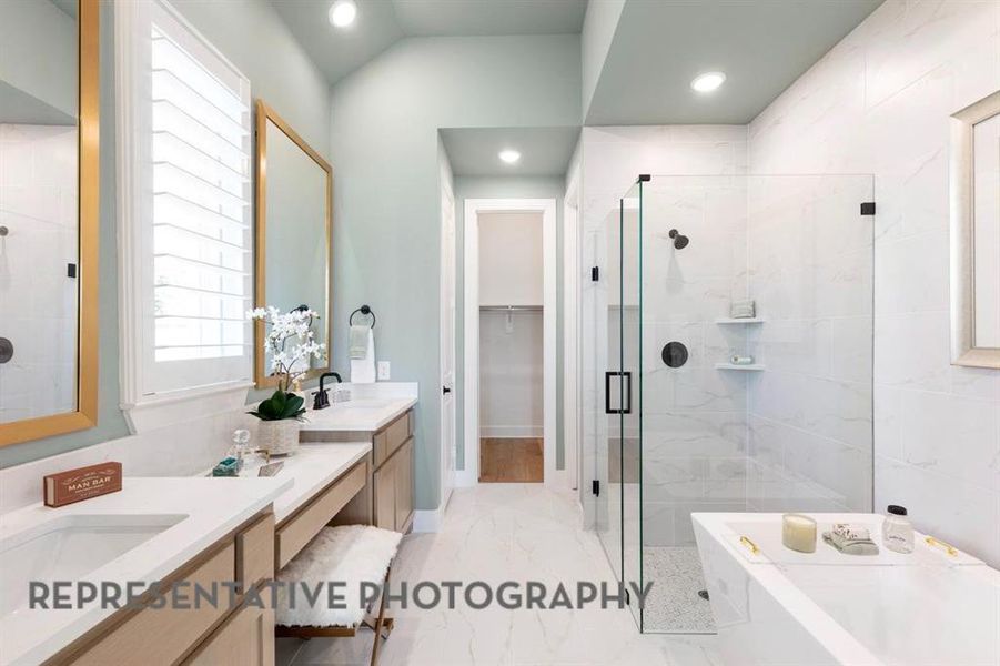 Bathroom with double vanity, a marble finish shower, a spacious closet, light marble finish floors, and a bath