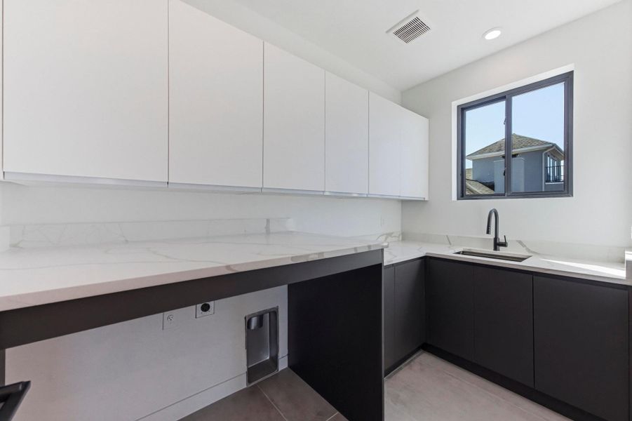 Laundry area with cabinet space and hookup for an electric dryer