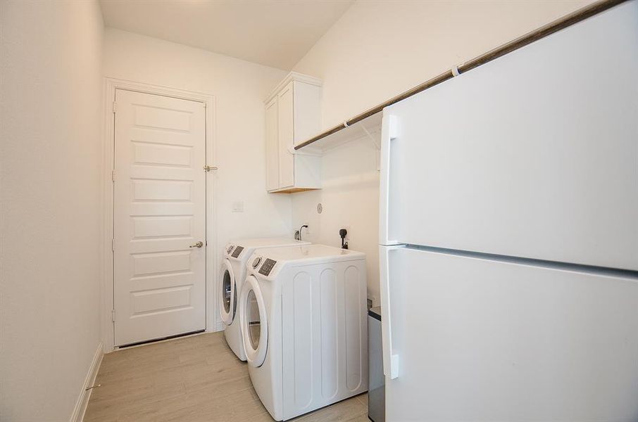 Utility room has gas and electric dryer options, room for additional refrigerator.