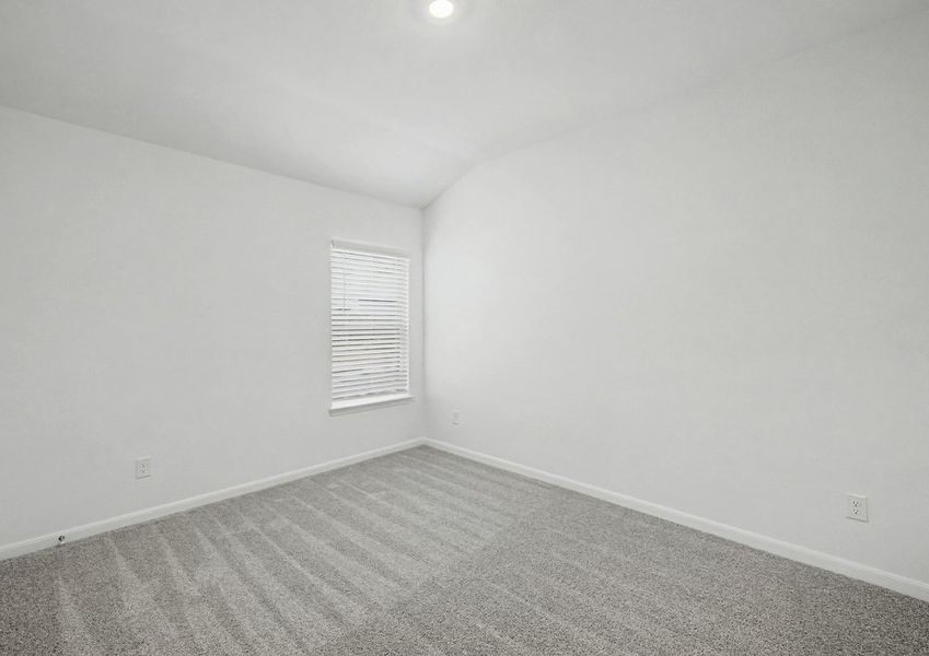 Secondary bedroom with tan carpet and recessed lighting.