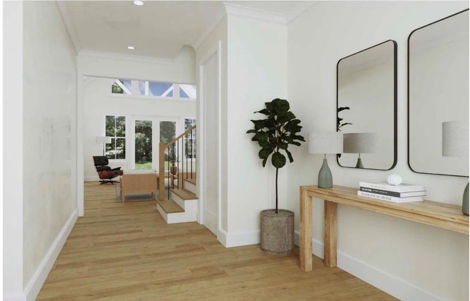 A graceful entry foyer welcomes you with light wood flooring and crisp white trim.