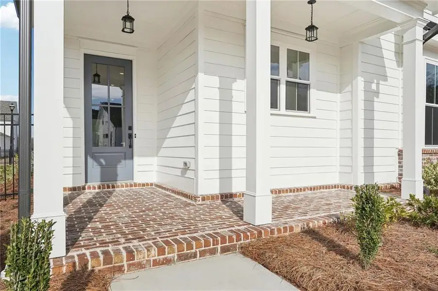Exterior details and patio area of a home in Promenade at Sawnee Village, Cumming (Image 4). Exterior details and patio area of a home in Promenade at Sawnee Village, Cumming (Image 4).