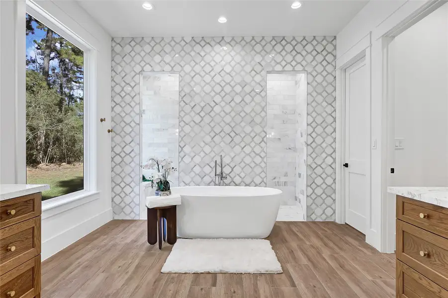 This luxurious and spacious bathroom directly connected to the main bedroom, offers separate vanity areas for added convenience and personal space.