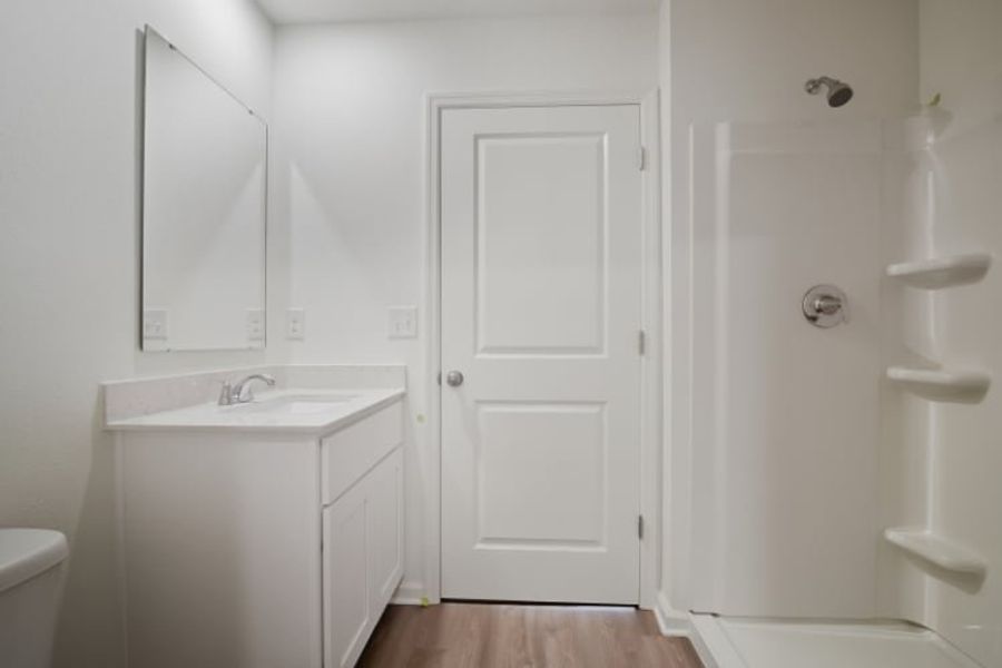 A bathroom with a sink and a mirror.