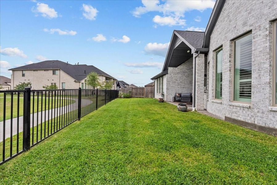 Step outside to enjoy the covered patio and expansive backyard overlooking the water — the perfect place to relax and unwind.