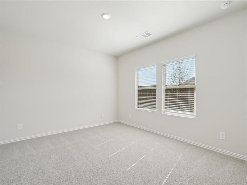 Unfurnished room featuring light colored carpet and baseboards