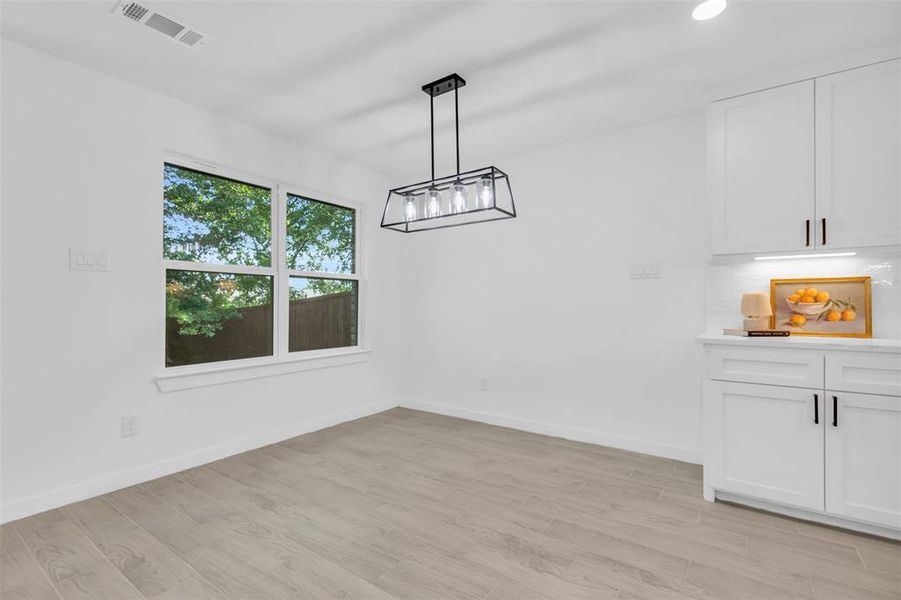 Unfurnished dining area featuring light wood-style flooring