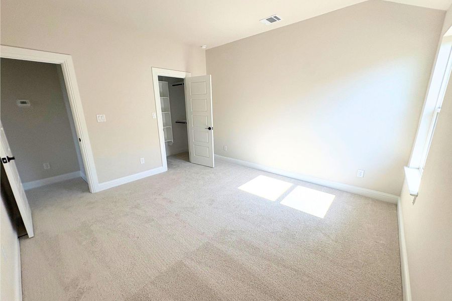 Plush carpeting and a walk-in closet define this tranquil upper-level bedroom. Plush carpeting and a walk-in closet define this tranquil upper-level bedroom.