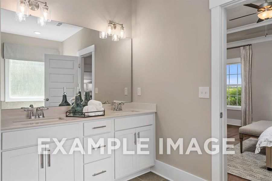 Bathroom with tile patterned floors, vanity, and ceiling fan