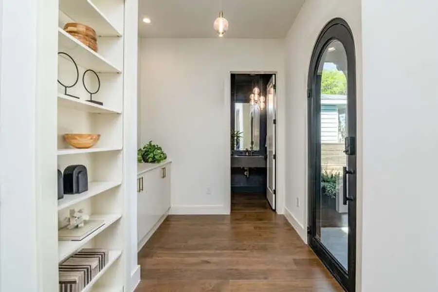 Corridor with dark wood-style floors, built in features, and recessed lighting Corridor with dark wood-style floors, built in features, and recessed lighting