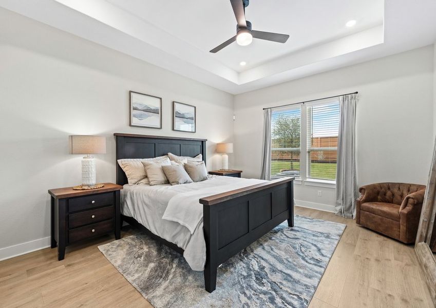 The master bedroom has a large window that lets in great, natural light and backyard views.