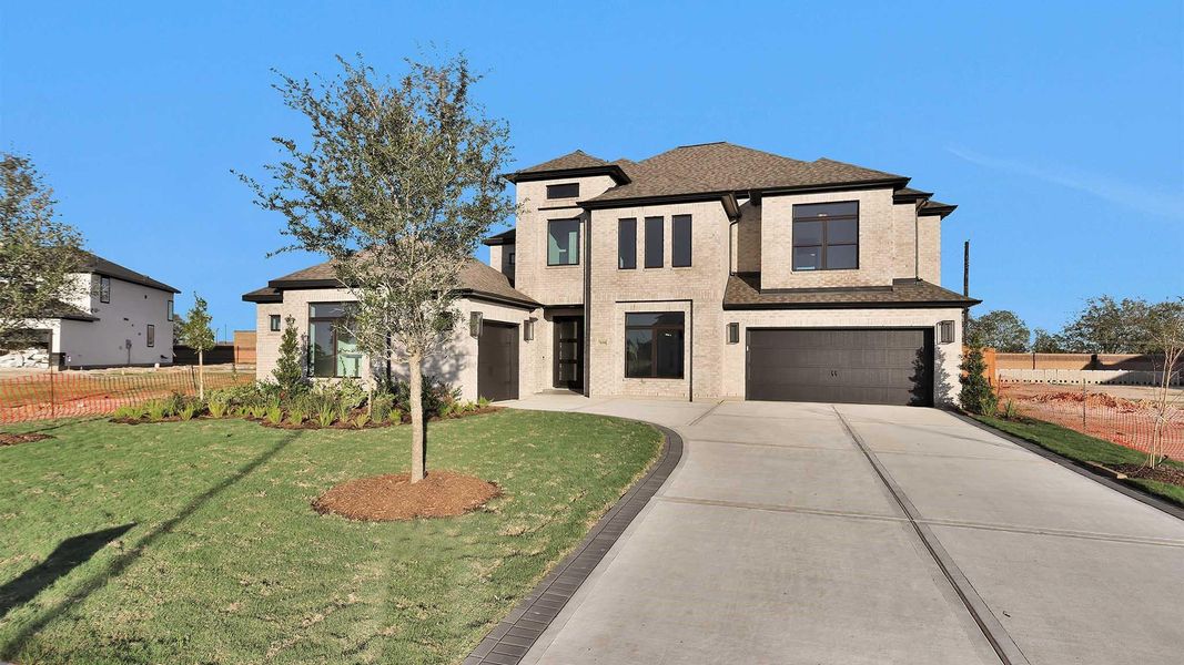 Front exterior of a new home in Elyson 70', Katy, TX, highlighting curb appeal (Image 12). Front exterior of a new home in Elyson 70', Katy, TX, highlighting curb appeal (Image 12).