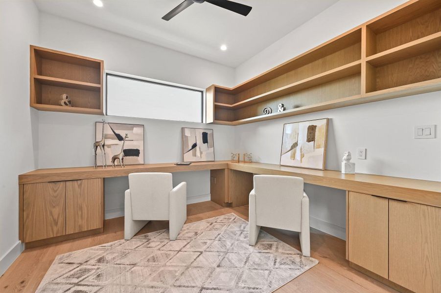Office with built in desk, light wood-type flooring, recessed lighting, and a ceiling fan