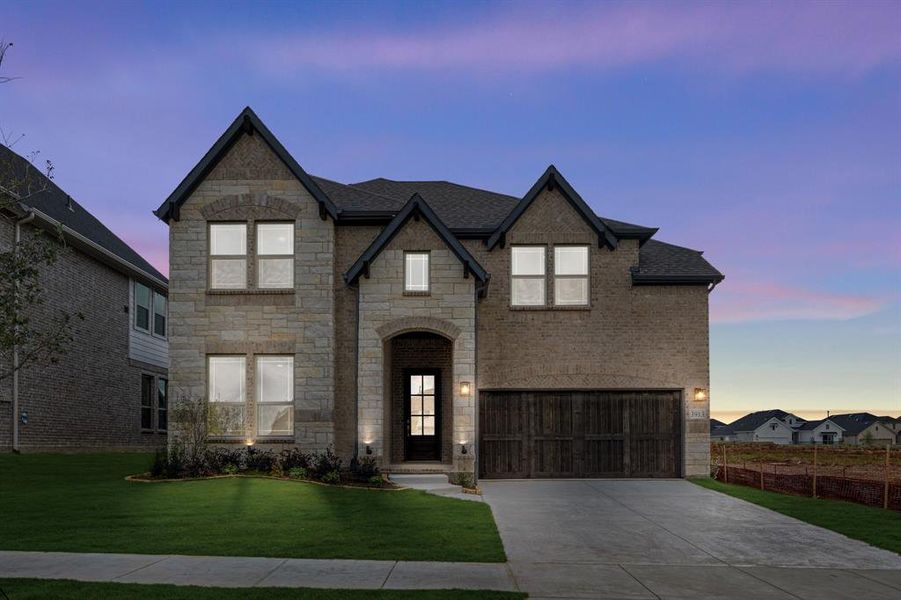 Front exterior of a new home in Painted Tree Woodland District 50, McKinney, TX, highlighting curb appeal (Image 1). Front exterior of a new home in Painted Tree Woodland District 50, McKinney, TX, highlighting curb appeal (Image 1).