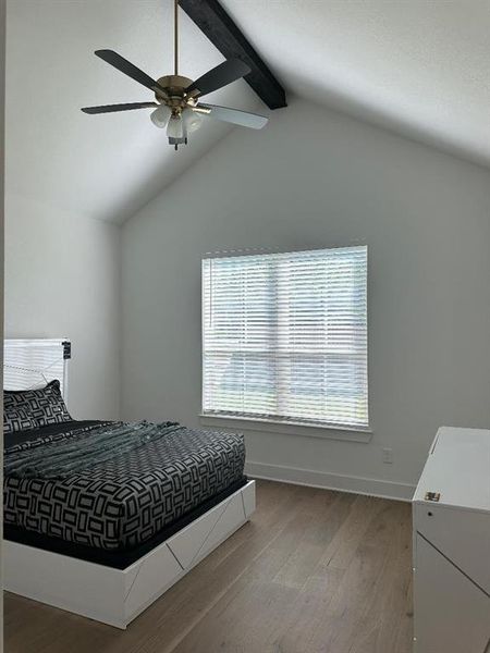 Vaulted ceiling with an exposed beam and ceiling fan
