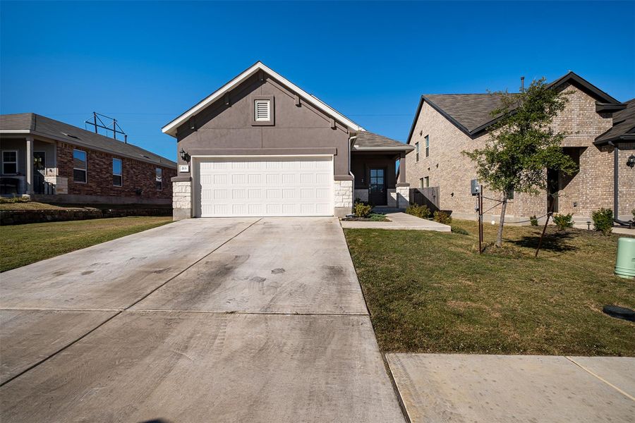 Front exterior of a new home in Sunfield, Buda, TX, highlighting curb appeal (Image 2).