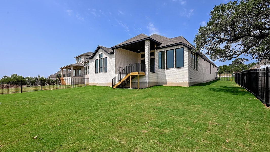 Kitchen with light countertops, recessed lighting, a sink, backsplash, and a center island with sink