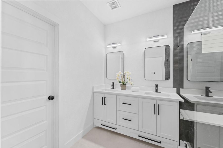The primary bath Includes a dual sink vanity space.