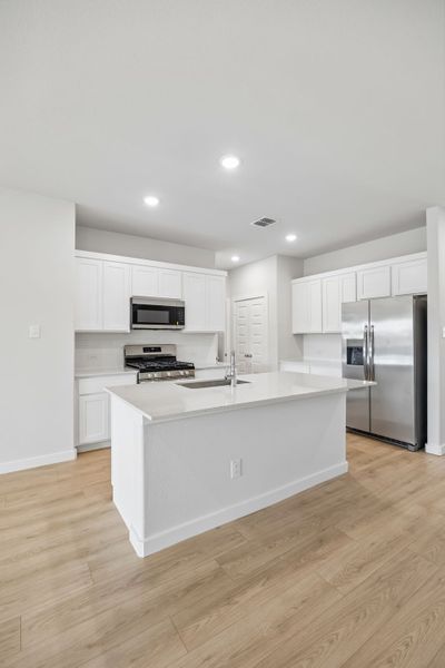 Kitchen in the Mesquite home plan by Trophy Signature Homes – REPRESENTATIVE PHOTO