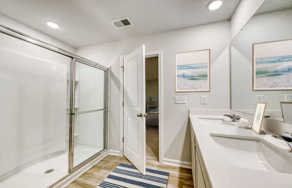 Owner's Suite bathroom showcases a large vanity with dual sinks and a walk-in shower.