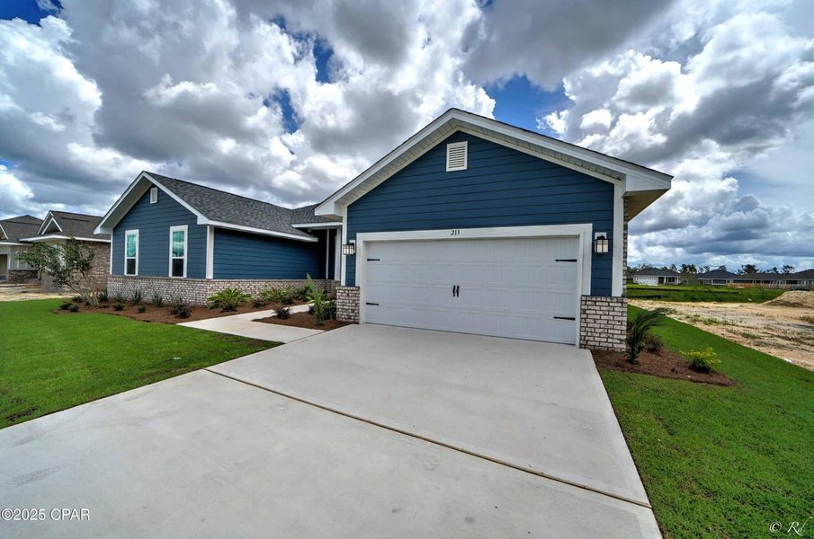 Front exterior of a new home in Cedar Creek at Deerpoint Lake, Panama City, FL, highlighting curb appeal (Image 16). Front exterior of a new home in Cedar Creek at Deerpoint Lake, Panama City, FL, highlighting curb appeal (Image 16).
