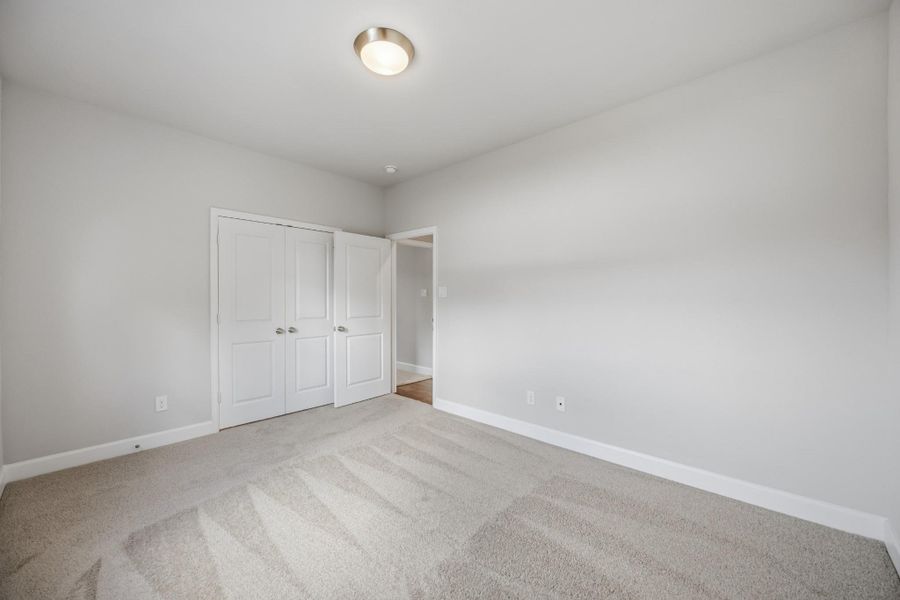 Perfectly sized, this secondary bedroom features a walk-in closet with custom shelving for maximum organization.