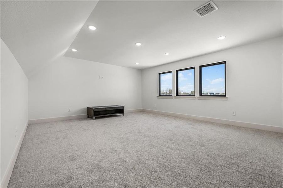 Massive bonus room space above garage on second story with windows overlooking west side of property.