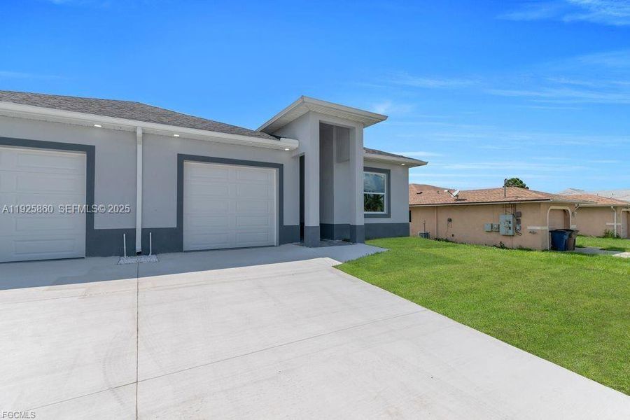 Front exterior of a new home in , Lehigh Acres, FL, highlighting curb appeal (Image 31).