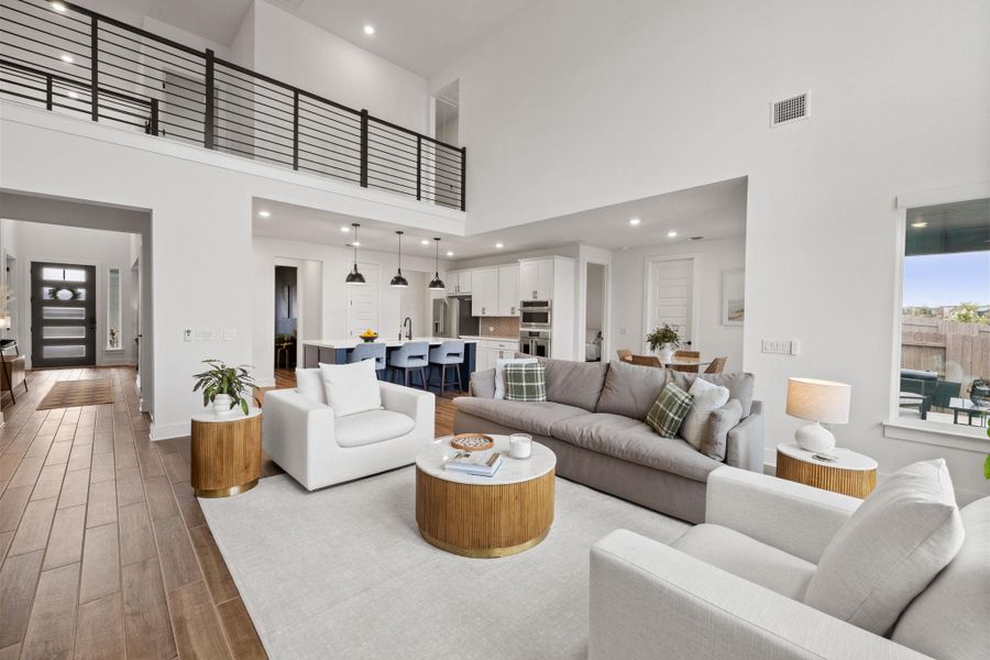 Living room featuring tiled finish floors, recessed lighting, towering ceiling and lots of natural light.