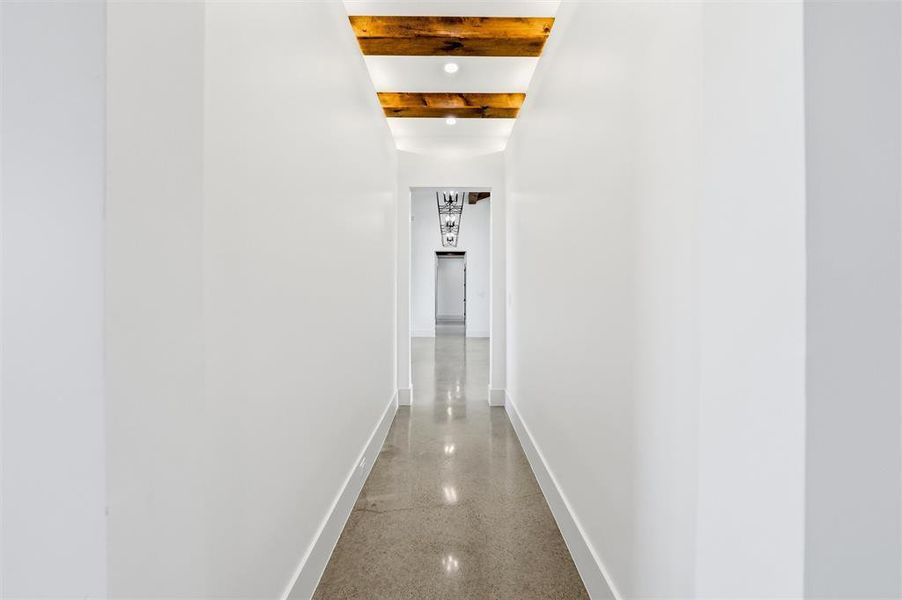 Corridor with dark speckled floor and beam ceiling Corridor with dark speckled floor and beam ceiling